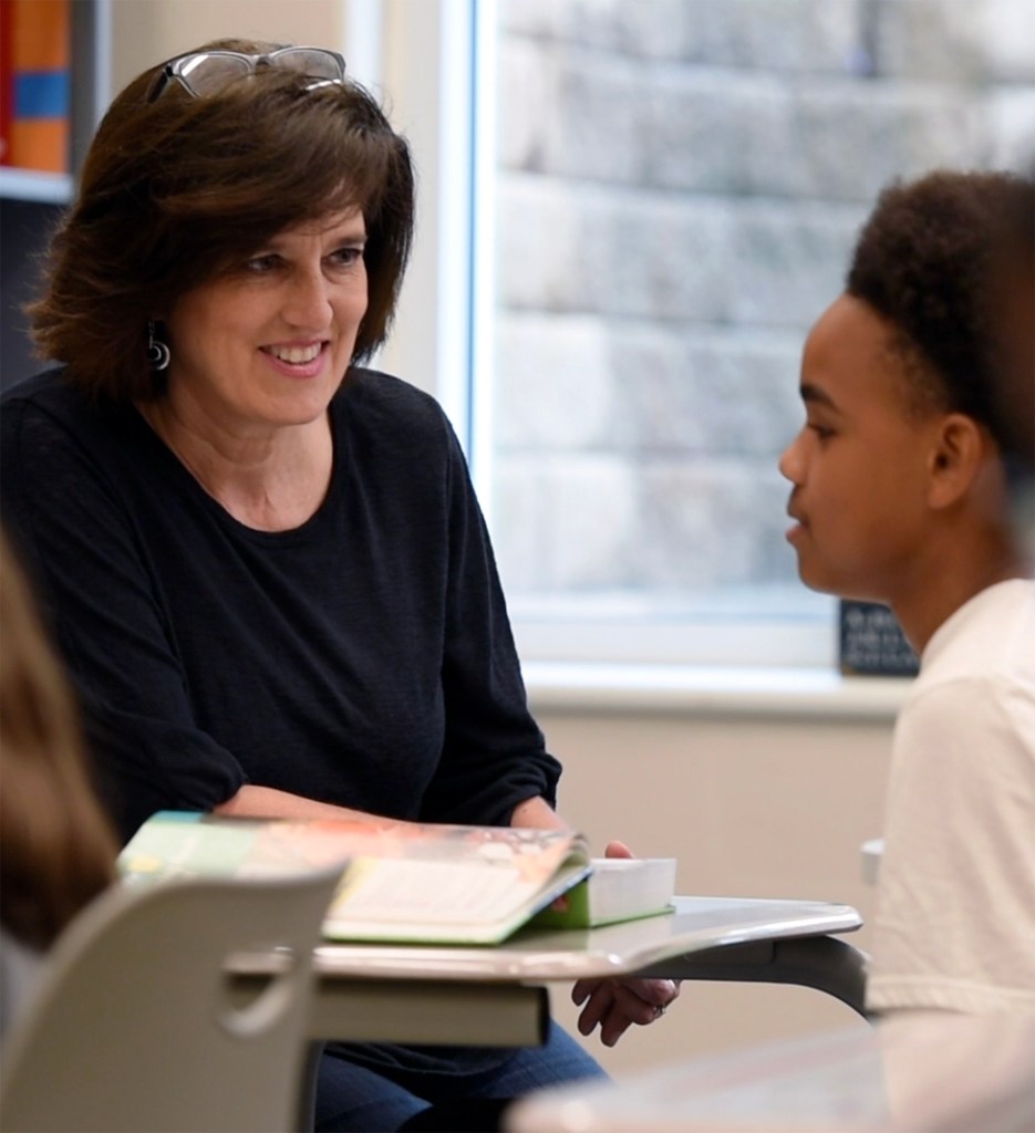Photo of teacher smiling at a student